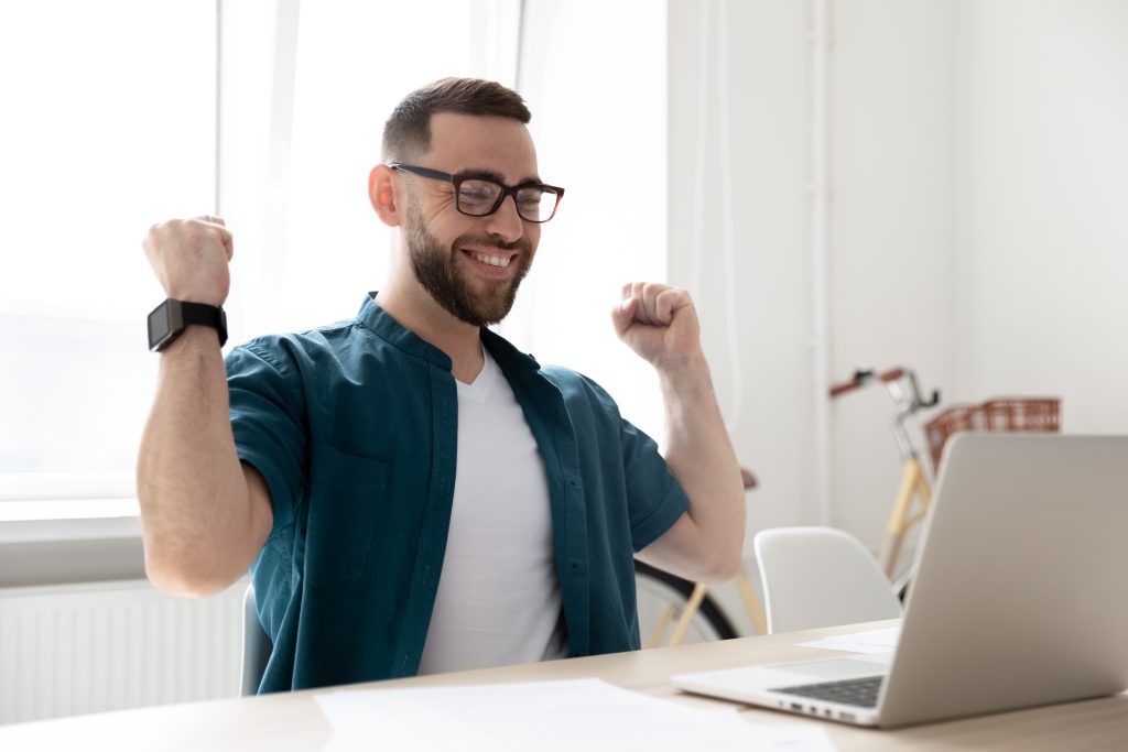Overjoyed,Young,Caucasian,Man,In,Glasses,Look,At,Laptop,Screen